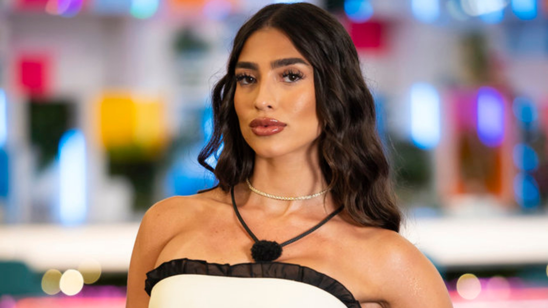 Parmida Keshani poses in a white dress on 'Love Island USA'